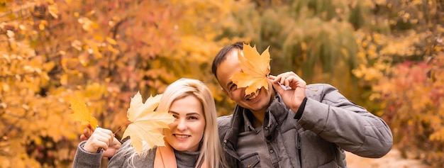 laughing smiling female and male, family in autumn park.