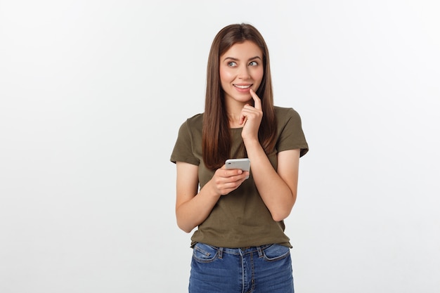 Laughing woman talking and texting on the phone isolated on a white .