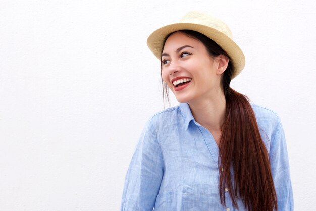 Laughing woman with long hair and hat on white background