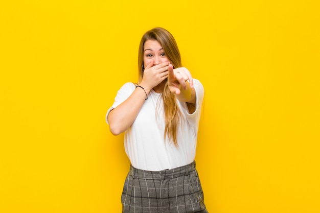 laughing at you, pointing to camera and making fun of or mocking you