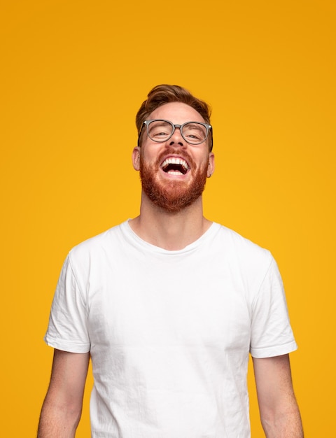 Laughing young bearded man in studio