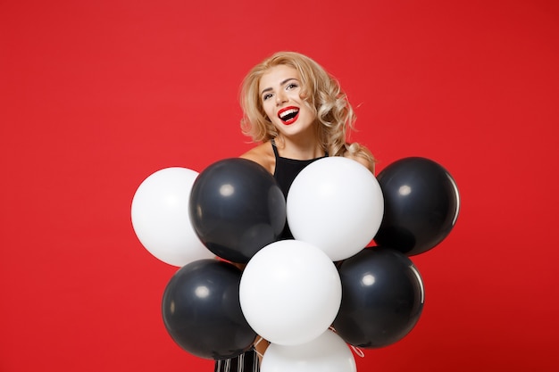 Laughing young woman in black clothes posing 