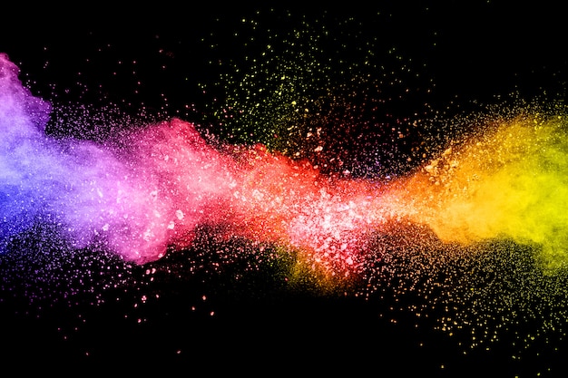 Launched colorful powder on black background.Color powder explosion.Colorful dust splashing.