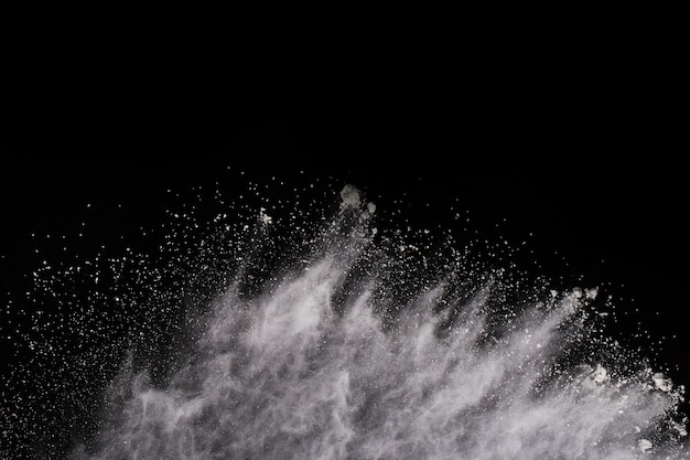 Launched white powder, isolated on black background.