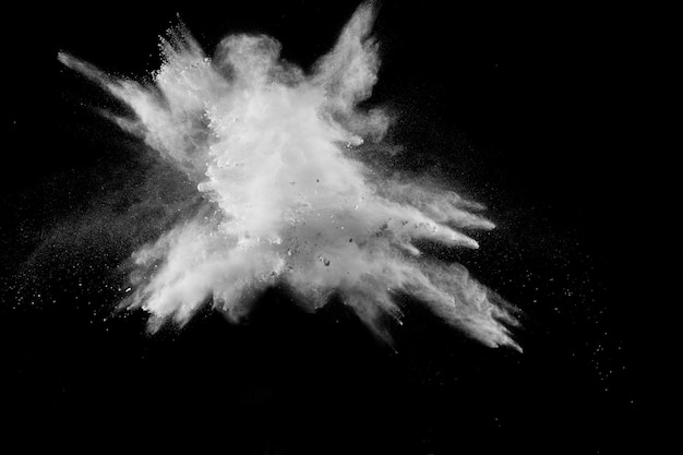 Photo launched white powder splash on black background.