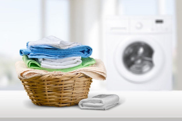 Photo laundry basket on blurred background of modern washing machine