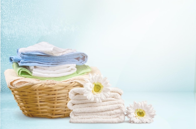 Laundry Basket with colorful towels on background