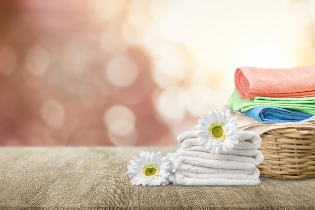 Laundry Basket with colorful towels on background