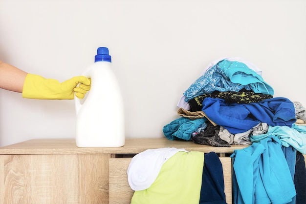 Laundry detergent bottle mockup on dirty clothes background Closeup