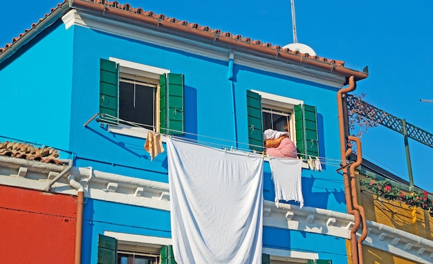 Laundry line with clothes in a Burano facade