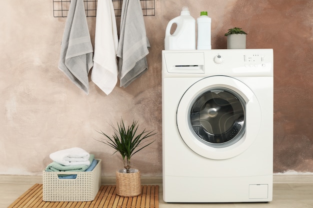 Laundry Room With Washing Machine Against Brown Wall