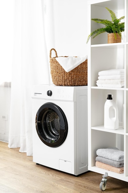 Laundry room with washing machine and basket with laundry