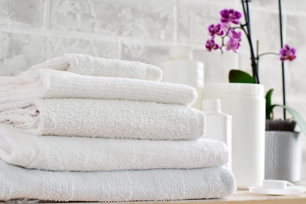 Photo laundry, white containers for cleaning products mockup and a stack of white cloths