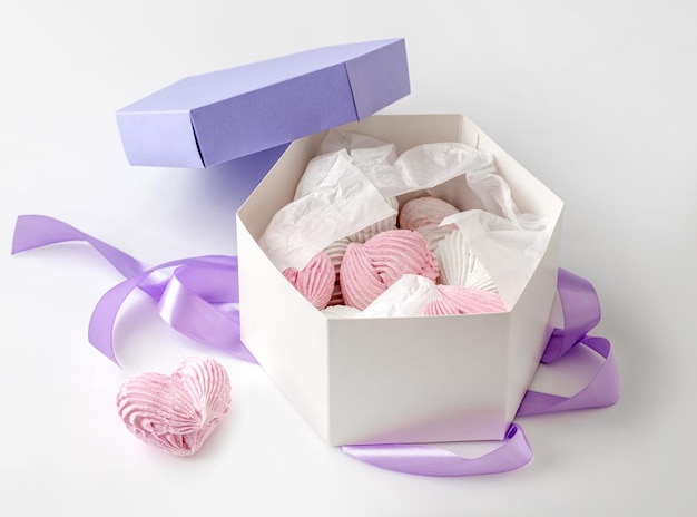 Lavander box with sweet homemade marshmallow pink and white color. Gift package with set of craft heart shape sweets desert