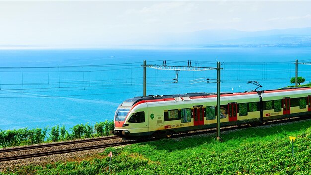 Lavaux, Switzerland - August 30, 2016: Running train at Lavaux Vineyard Terraces hiking trail at Lake Geneva and Alpine mountains, Lavaux-Oron district, Switzerland