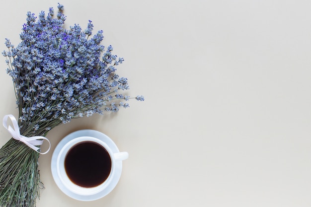 Lavender bouquet and coffee on beige table