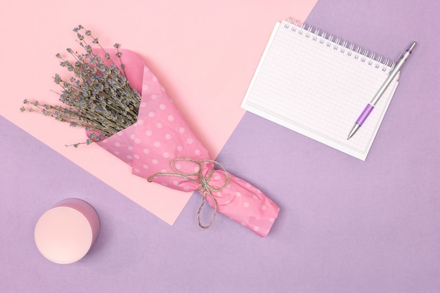 Lavender bouquet, cosmetic jar, blank notebook. Women lifestyle minimal concept