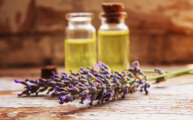 Photo lavender essential oil in a small bottle. selective focus. nature.