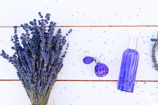 Lavender flowers bouquet and lavender oil in blue bottle