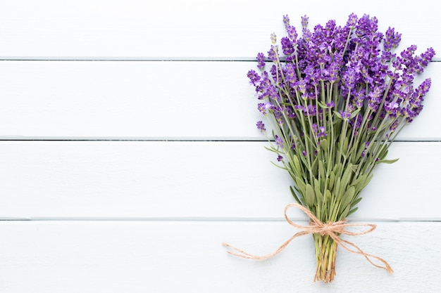 Lavender flowers, bouquet on rustic table, overhead.