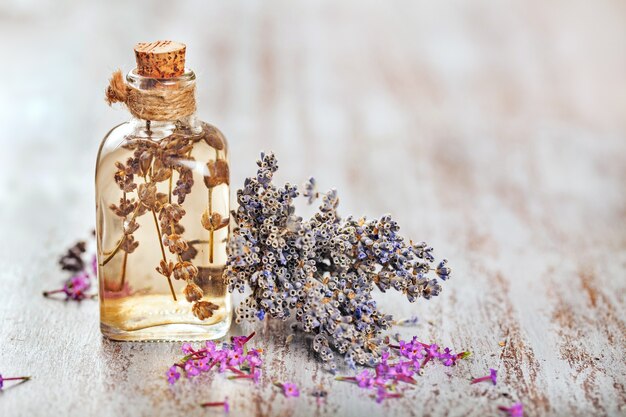Lavender herb flower water in a glass bottle with flowers