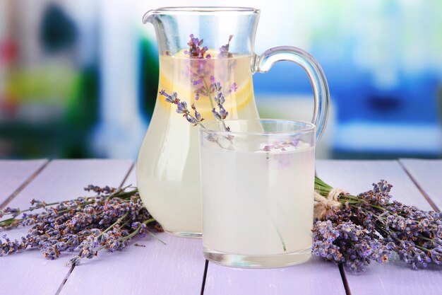 Lavender lemonade on violet wooden table on bright background