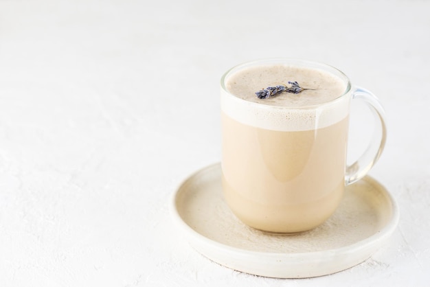 Lavender raf coffee in a glass mug. Russian drink. Horizontal orientation, copy space.