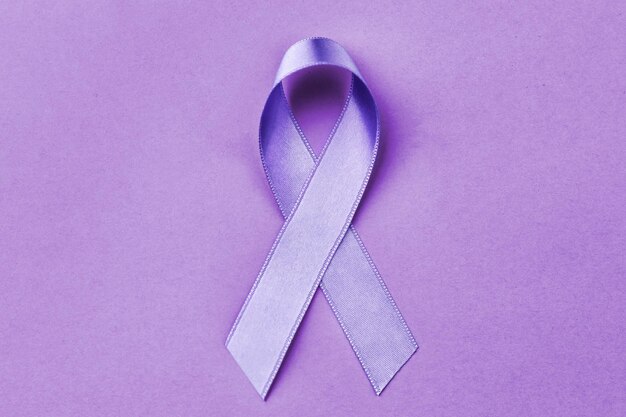 Lavender ribbon on color background cancer and epilepsy concept