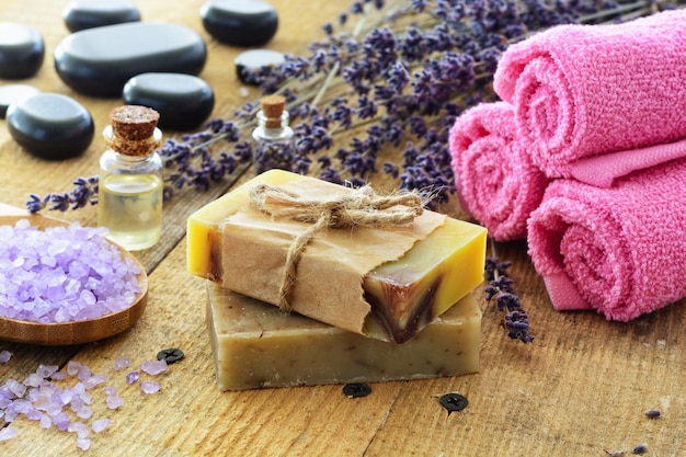 Lavender soap and salt on rustic wooden board