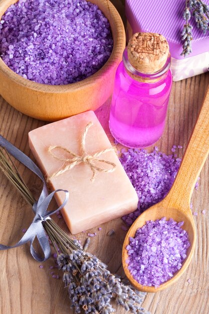 Lavender treatment soap and sea salt on wooden table