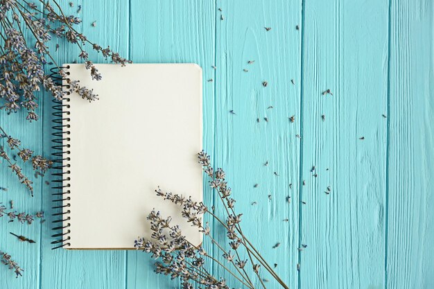 Photo lavender with notebook on wooden background