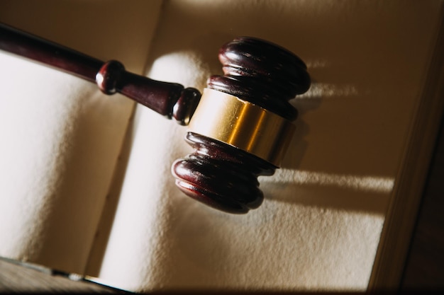 Photo law books and scales of justice on desk in library of law firm jurisprudence legal education concept