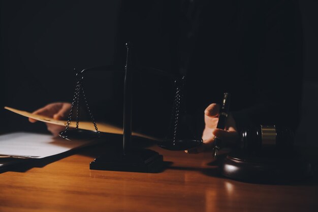 law books and scales of justice on desk in library of law firm jurisprudence legal education concept