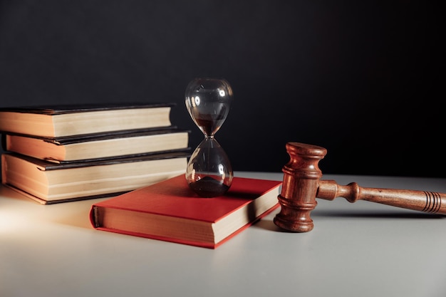 Law code hourglass on red book and judge gavel