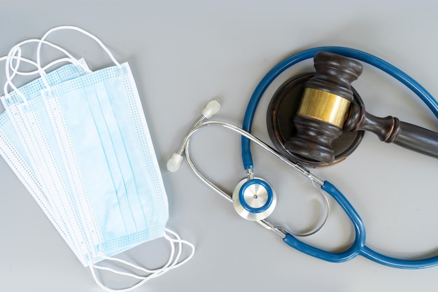 Law gavel, stethoscope and face anti virus masks, medical law concept