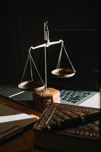 law legal technology concept judge gavel on computer with scales of justice on desk of lawyer