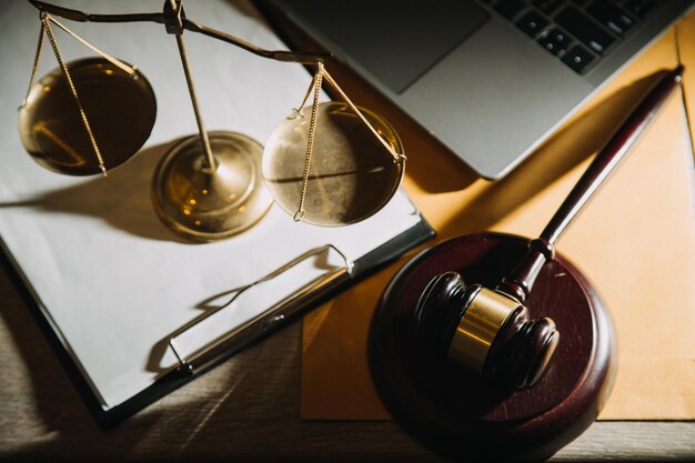 law legal technology concept judge gavel on computer with scales of justice on desk of lawyer