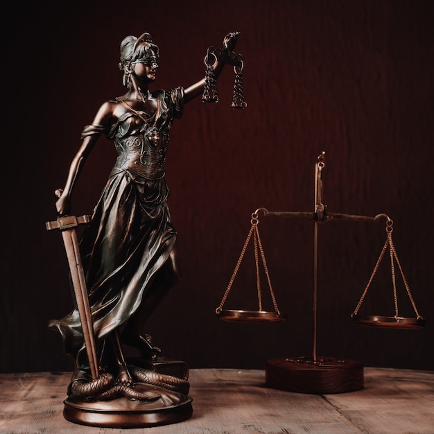 Law offices of lawyers legal statue Greek blind goddess Themis bronze metal statuette figurine with scales of justice. - Image