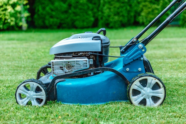 Lawn mower on the grass closeup