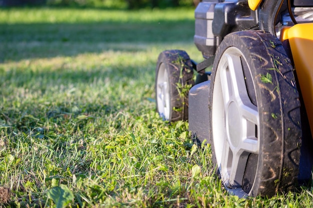 A lawn mower is being used to mow the grass