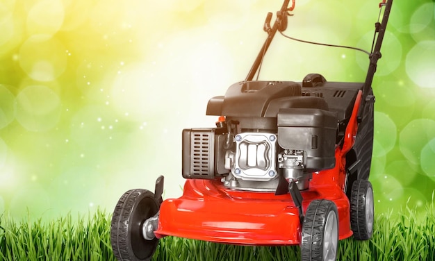 Lawn mower on a lawn on blurred background