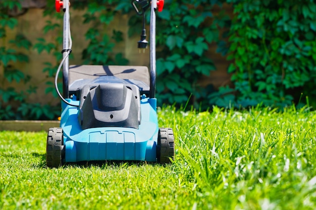 Lawnmower electric machine trimming green grass lawn cutting