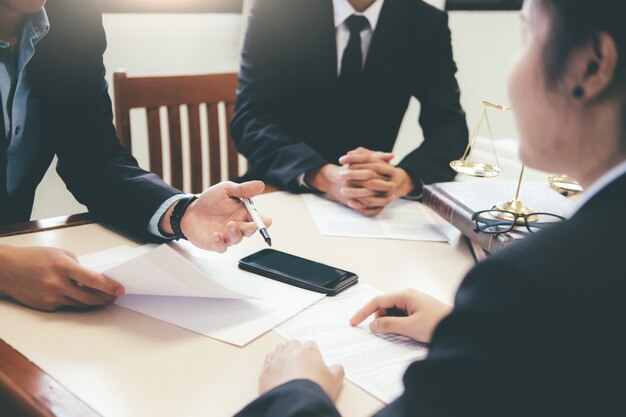 Photo lawyer and attorney having team meeting at law firm.