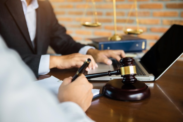 Lawyer businessman and two business partners working together in office Businessmen sitting at desk and making notes