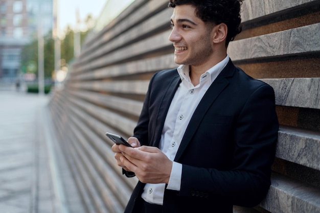 The lawyer communicates via SMS via phone with the client A business man is dressed