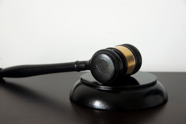 Lawyer gavel on wooden table with white background