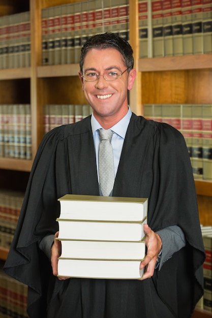 Lawyer holding books in the law library