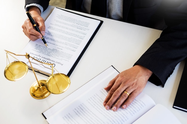 lawyer judge reading writes the document in court at his desk