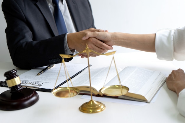Photo lawyer or judge with gavel and balance handshake