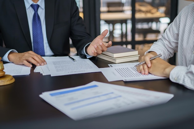 Lawyer Legal counsel presents to the client a signed contract with gavel and legal law justice and lawyer Business partnership meeting concept